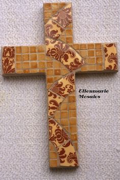 the cross is made out of wood and has floral designs on it, as well as an intricate design