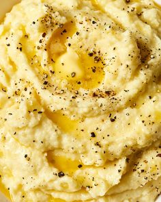 mashed potatoes in a white bowl topped with seasoning