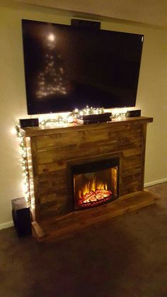 a fireplace with lights and a flat screen tv above it