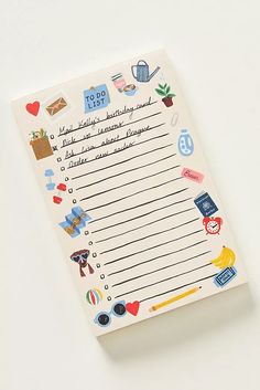 a notepad with stickers and writing on it