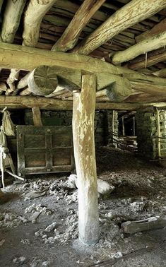 an old run down building with wood beams and exposed flooring in the middle of it