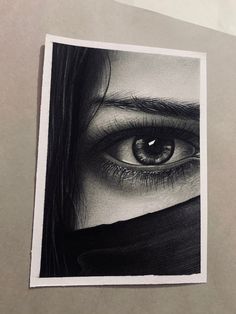 a black and white photo of a woman's face with her eyes covered by a scarf