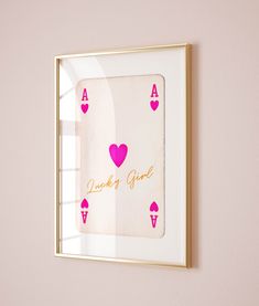 a pink and gold framed card game with hearts on it