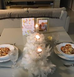 the table is set with dishes and candles