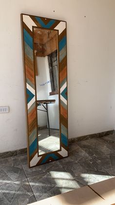 a mirror sitting on top of a tiled floor