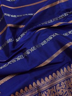 SILK MARK CERTIFIED !!Gorgeous Pure KatanSilk Blue Color with Copper and Slier Zari Work. Strips Sarees in Copper and Sliver Zari with Floral Buttas on the Pallu Soft, light weight and easy to drape Saree. The Strips are dense towards the pallu and get scattered the other end. Item : SareeColor : Blue ColorBase Fabric : Pure Katan Silk Blouse piece : Comes with Blouse pieceBlouse material : Pure Katan SilkFall & Edging (Yes/No) : YesComes with Silk Mark Certificate (Yes/No) : Yes Disclaimer -:- Blue Raw Silk Blouse Piece With Traditional Patterns, Festive Blue Raw Silk Blouse Piece, Blue Zari Work Blouse Piece For Celebration, Blue Katan Silk Salwar Kameez With Zari Work, Blue Banarasi Silk Kurta With Zari Work, Blue Katan Silk Salwar Kameez With Traditional Drape, Blue Banarasi Silk Dupatta For Celebration, Festive Blue Salwar Kameez With Zari Weaving, Blue Bollywood Salwar Kameez With Zari Weaving