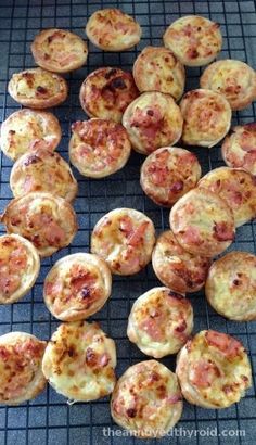 small pizzas on a cooling rack ready to be baked in the oven or used as appetizers