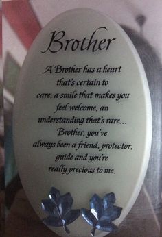 a plaque with two blue flowers on it that says,'brother a brother has a heart that's certain to care, a smile that makes you feel welcome