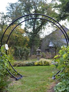 an arch in the middle of a garden