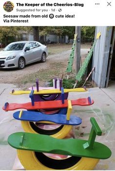 a bunch of different colored skateboards stacked on top of each other in front of a car