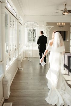 the bride and groom are walking down the hall