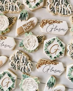 decorated cookies are arranged on a table with the names of their wedding day and date