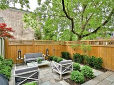 an outdoor patio with seating and trees in the background