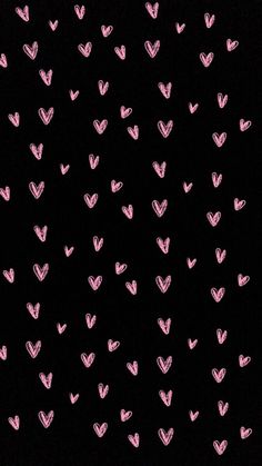 pink hearts are drawn on black paper