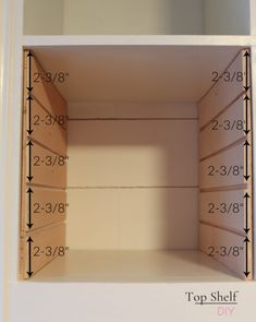 an empty shelf with measurements for the top shelf