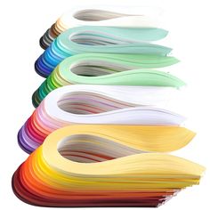 many different colors of paper are arranged in the shape of curved lines on a white background