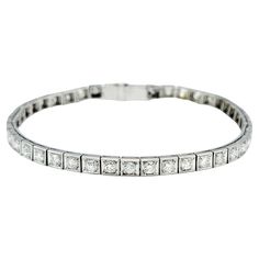 The inner circumference of this bracelet measures 6.13 inches and will comfortably fit up to a 6 inch wrist. This stunning round diamond tennis bracelet is exquisitely crafted in platinum with a sophisticated squared design and intricate milgrain texturing. This stunning bracelet features a continuous line of brilliant round diamonds, each set in a meticulously detailed squared frame. The milgrain texturing along the edges adds a touch of vintage charm and enhances the overall elegance of the piece. The platinum setting provides a luxurious backdrop for the diamonds, ensuring a timeless and refined look. Perfect for special occasions or adding a touch of glamour to everyday wear, this diamond tennis bracelet is a timeless addition to any fine jewelry collection. This piece is in very good