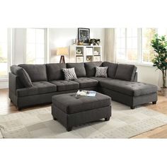 a living room with a sectional couch and ottoman