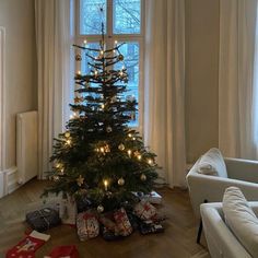 a small christmas tree in the corner of a living room