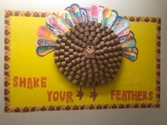 a paper turkey made out of toothbrushes on a yellow sign that says shake your feathers