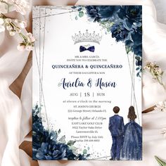 an elegant wedding card with blue flowers and a crown on the front, is shown