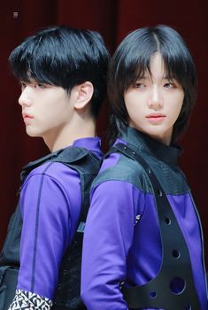 two male models with black hair and purple shirts