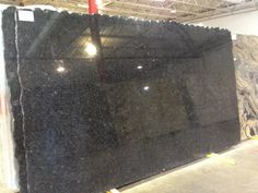 a large black granite slab in a warehouse