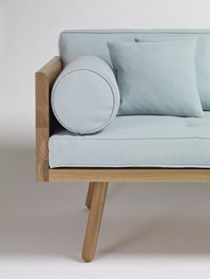 a light blue couch with pillows on it