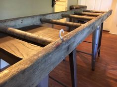 a row of wooden benches sitting on top of a hard wood floor