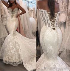 the back of a white wedding dress with lace on it