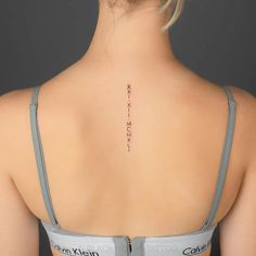 the back of a woman's neck with writing on it