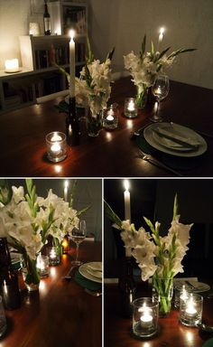 the table is set with candles and flowers in glass vases, which are lit up