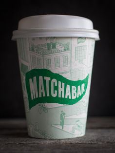 a starbucks cup with the word matchabe printed on it's sleeve and lid