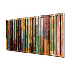 a multicolored wall hanging on the side of a building with vertical lines painted all over it