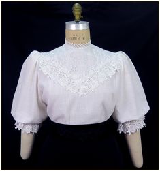 "Linen/Viscose. Color: White. Beautiful lightweight woven white linen blend fabric blouse with white leaf and vine front lace yoke. Scalloped edged rose pattern lace trim around front bodice and elastic cuffs. Lightly gathered short full sleeves and button back closure. Generously cut for comfort. Dry clean. Circa 1898-1910. Made in U.S.A. Sizes: SM, MED, LG & XLG. Blouses ordered by bust measurement, inches:  BUST           SIZES 32\" - 34\"     SMALL 35\" - 39\"     MEDIUM 40\" - 44\"     LARGE 45\" - 49\"     XLARGE Blouses ordered by bust measurement, centimeters: SMALL       81 cm - 86 cm MEDIUM    88.9 cm - 99 cm LARGE      101.6 cm - 111.76 cm XLARGE    114 cm - 124.46 cm HOW TO MEASURE TO DETERMINE YOUR SIZE: BUST: Measure the fullest part of your bust, we add the fitting ease and Jacquard Skirt, Crochet Vintage, Rose Lace, Lace Short, White Leaf, Full Sleeves, Pin Tucks, Rose Pattern, Striped Linen