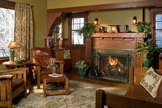 a living room filled with furniture and a fire place in the middle of a room