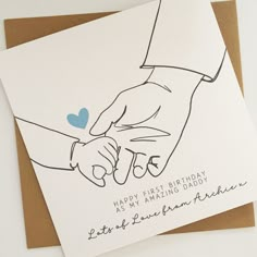 two greeting cards with hand drawn hands holding each other's fingers, one has a blue heart on it