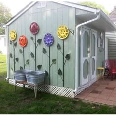 a garden shed with flowers painted on the side