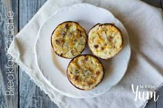 three cooked egg muffins on a white plate