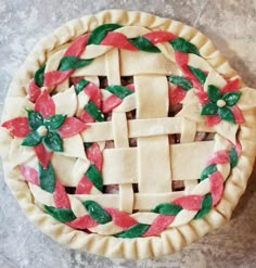 a pie that is decorated with red and green decorations on it's crusts