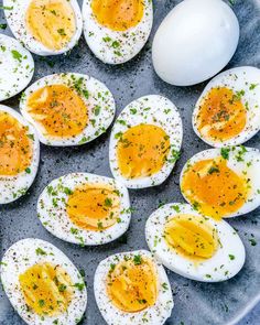 several hard boiled eggs on a plate with parsley