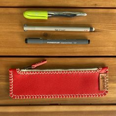 "Red leather pencil case, makeup case, tampons holder.  It is a minimalist case, designed to hold four or five pens, but can also be used for make-up, tampons, etc.  It measures 8.3 x 2.4\", is made of top quality red leather and is entirely hand-stitched with strong waxed thread. The result is a young and original case, a perfect gift for any kind of person.  It is available in other colors: www.etsy.com/es/shop/Pielroja?ref=search_shop_redirect&section_id=27939669 SHIPPING AND RETURNS The order will be ready in 5-10 days. The shipping time will depend on the destination: the package is sent with Correos Express to Spain (1-2 days), Correos Paq Light to Europe (3-5 days) and DHL express to the rest of the world (2-5 days). I accept exchanges and returns as long as they are made within ten Cheap Red Pencil Case As Gift, Affordable Red Pencil Case For Gift, Cheap Red Travel Pencil Case, Cheap Red Pencil Case With Pen Holders, Affordable Red Pencil Case With Pen Holders, Rectangular Red Pencil Case For Travel, Red Pencil Case, Rectangular Red Pencil Case With Pen Holders, Red Pencil Case With Zipper Closure