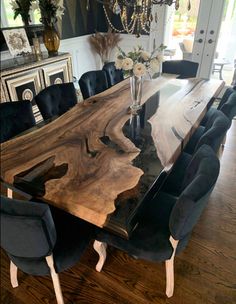 a large wooden table with black chairs around it