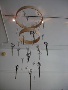 several pairs of scissors hanging from the ceiling