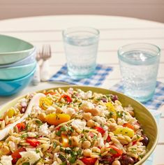 a bowl filled with pasta salad on top of a table