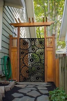 an iron gate is on the side of a house