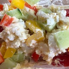 there is a salad with fruit and cheese on it