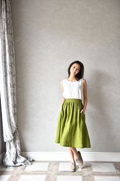 "SIZING AND FIT The skirt is true to size - we recommend choosing the size you usually wear. Before placing an order check our size chart below. The model in the picture is wearing size XS, color: Moss green The approximate length of the skirt measured at the side seam is ±70cm ⅼ ±27.5\" SIZE XS Bust: around 33.5\" / 85cm Waist: around 26\" / 66cm Hips: around 36\" / 91 cm SIZE S Bust: around 35.5\" / 90 cm Waist: around 28\"/ 71 cm Hips: around 38\"/ 97 cm SIZE M Bust: around 37.5\" / 95 cm Wai Flowy Green Skirt With Pockets, Green Flowy Skirt With Pockets, Green Midi Skirt With Pockets, Green Long Skirt With Pockets, Green Tiered Skirt With Pockets, Relaxed Fit Full Skirt With Pockets, Solid Color Tiered Skirt With Pockets, Fitted Green Skirt With Side Pockets, Green Mini Skirt With Side Pockets