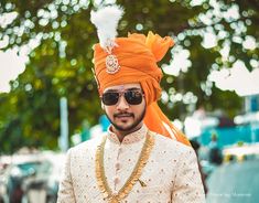 a man wearing an orange turban and sunglasses