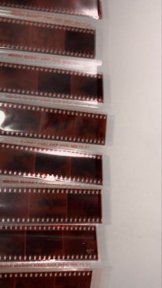 film strips are lined up on the wall to be used as art work or display